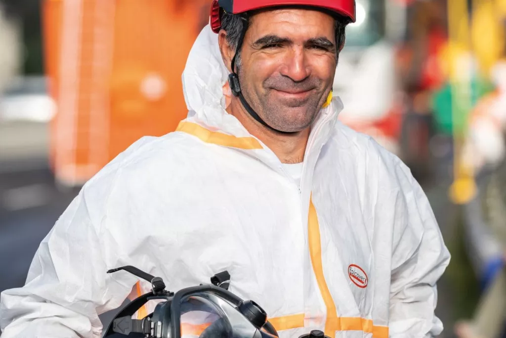 Colas employee wearing PPE for asbestos removal