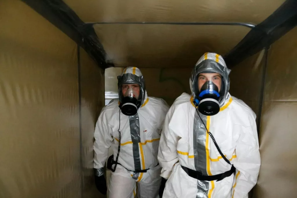Two employees wearing PPE on a Colas asbestos removal site