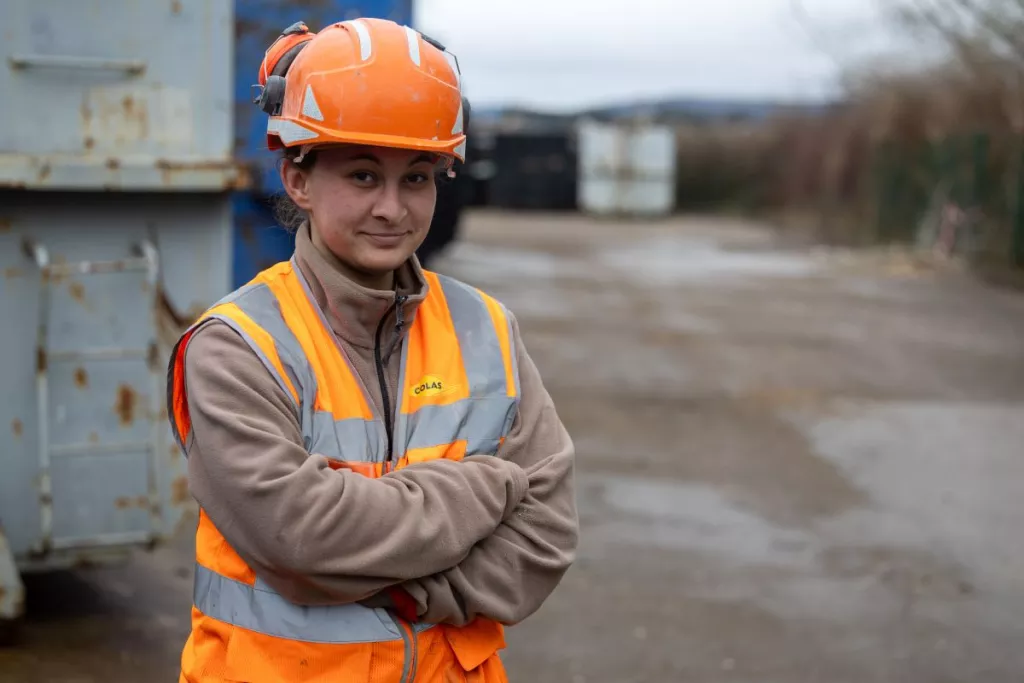 Colas employee operating machinery