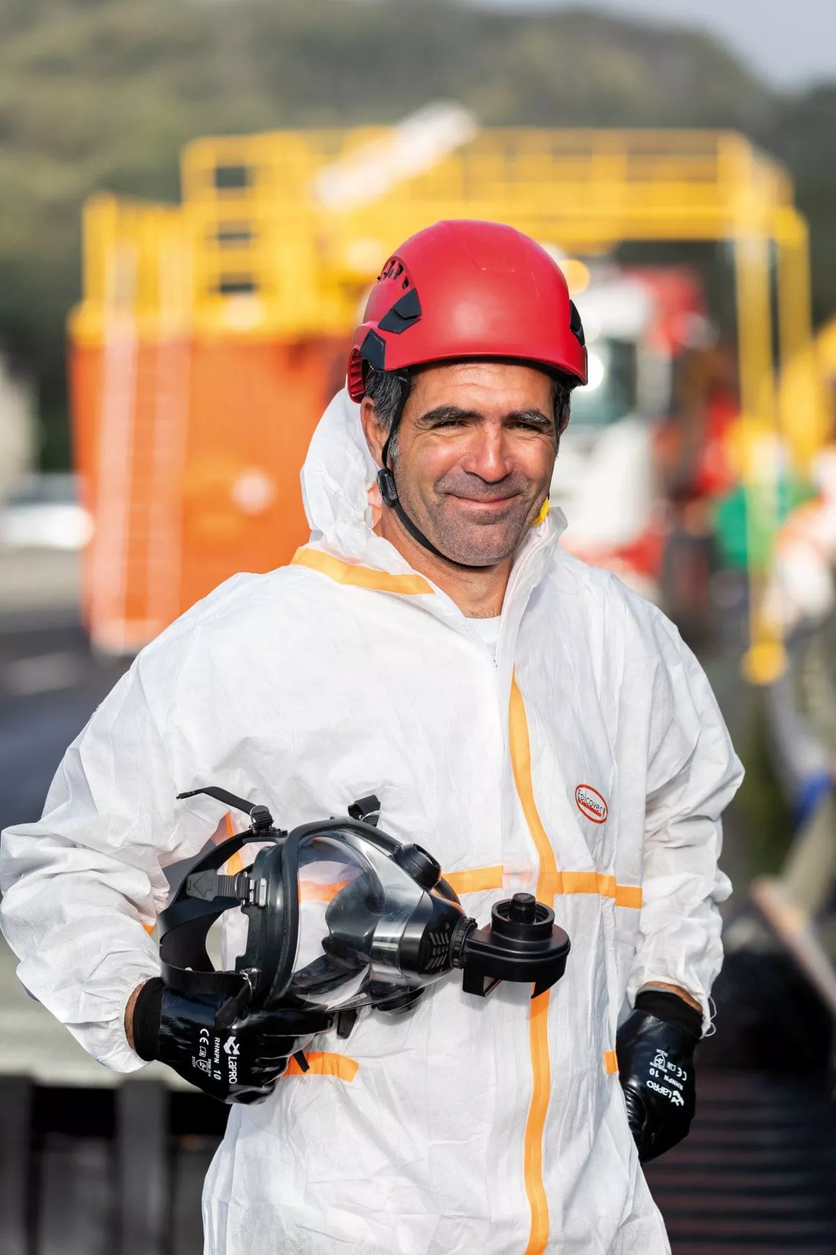 Colas employee wearing PPE for asbestos removal
